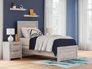Ashley Furniture Broachmyn Bed with a wood frame and upholstered headboard, showcasing a classic bedroom furniture design.