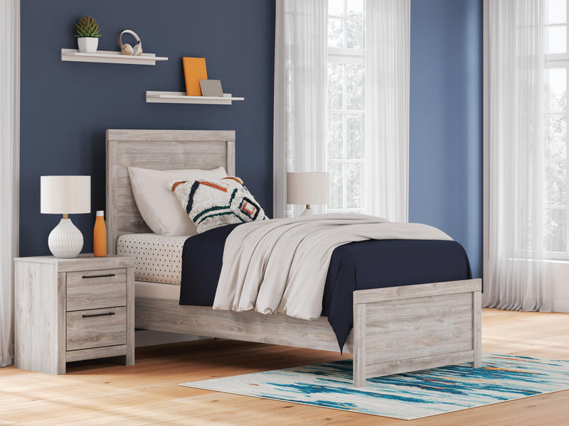 Ashley Furniture Broachmyn Bed with a wood frame and upholstered headboard, showcasing a classic bedroom furniture design.