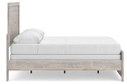 Ashley Furniture Broachmyn Bed with a stylish wooden frame and upholstered headboard, shown in a modern bedroom setting.