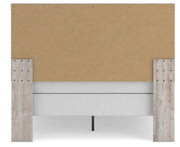 Ashley Furniture Broachmyn Bed with a sturdy wooden frame and upholstered headboard, shown from the back view.