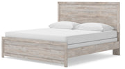Ashley Furniture Broachmyn Bed with a wood frame and upholstered headboard, shown from an angled view.