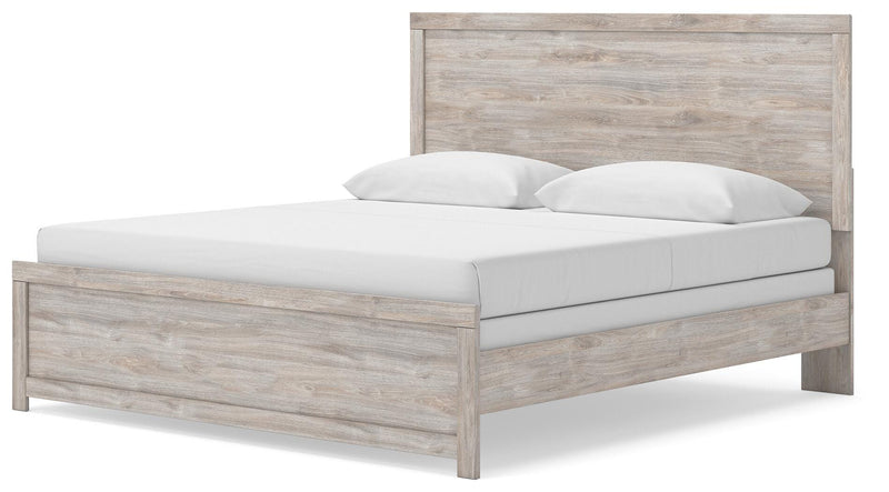 Ashley Furniture Broachmyn Bed with a wood frame and upholstered headboard, shown from an angled view.