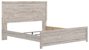 Ashley Furniture Broachmyn Bed with a stylish wooden frame, shown from an angled view highlighting the headboard and craftsmanship.
