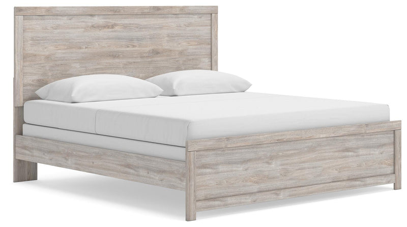 Ashley Furniture Broachmyn Bed with a stylish frame and headboard, shown from an angled side view in a modern bedroom setting.