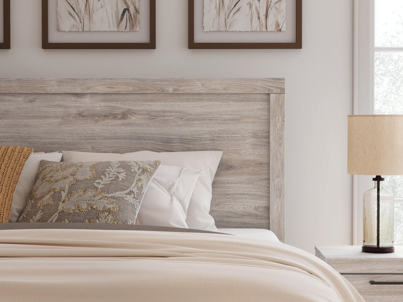 Ashley Furniture Broachmyn Bed with detailed close-up of the headboard featuring intricate woodwork and rich finish.