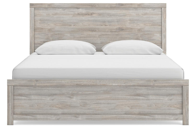 Ashley Furniture Broachmyn Bed with headboard and bedding in a cozy bedroom setting