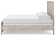 Ashley Furniture Broachmyn Bed with a sturdy frame and elegant design, shown from the side view in a bedroom setting.