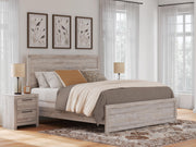 Ashley Furniture Broachmyn Bed with a wooden frame and upholstered headboard, showcasing its elegant design and craftsmanship.