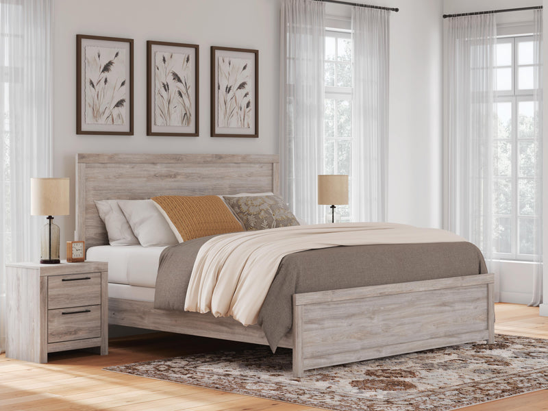 Ashley Furniture Broachmyn Bed with a wooden frame and upholstered headboard, showcasing its elegant design and craftsmanship.