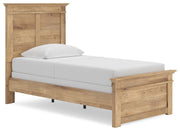 Ashley Furniture Makidern bed frame with a sleek upholstered headboard and modern design, shown from a side angle.