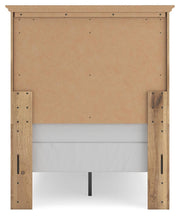 Ashley Furniture Makidern Bed with a stylish headboard and dark wood finish, shown from a side angle.