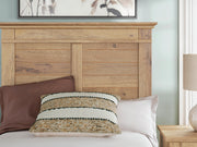 Ashley Furniture Makidern Bed with detailed headboard and sturdy frame, shown in a modern bedroom setting.