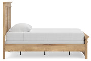 Ashley Furniture Makidern Bed with a beige upholstered headboard and wooden side panels, showcased in a modern bedroom setting.