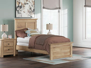 Ashley Furniture Makidern Bed with wood frame and upholstered headboard, shown in a modern bedroom setting.