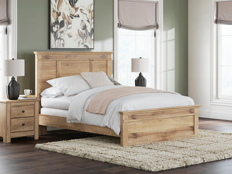 Ashley Furniture Makidern Bed with upholstered headboard and wooden frame, shown in a cozy bedroom setting.