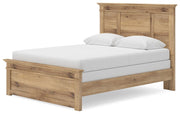 Ashley Furniture Makidern Bed shown from an angled view, featuring a wooden frame with a tall, paneled headboard and classic design.