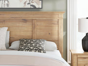 Ashley Furniture Makidern Bed with detailed wood finish and elegant headboard, showcased in a well-lit bedroom setting.