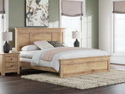 Ashley Furniture Makidern Bed with a stylish headboard and wooden frame, shown in a cozy bedroom setting.