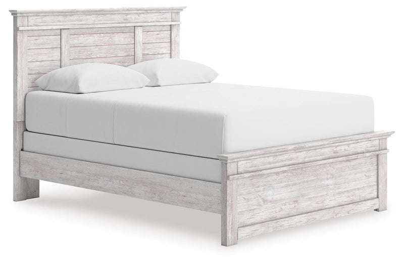Ashley Furniture Makidern Bed with a stylish headboard and wooden frame, shown from a side angle.
