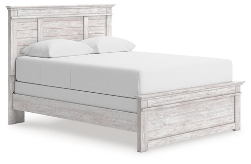 Ashley Furniture Makidern Bed with a stylish headboard and wooden frame, shown from a side angle.