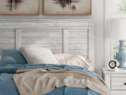 Ashley Furniture Makidern Bed with detailed wood finish and elegant headboard, showcasing a stylish bedroom centerpiece.