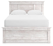 Ashley Furniture Makidern bed with a headboard featuring a contemporary design and soft upholstery, displayed in a bedroom setting.