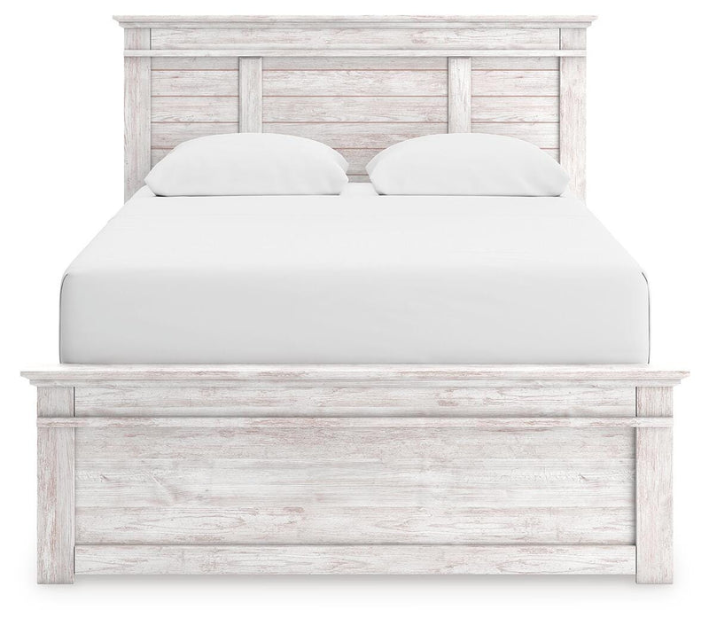 Ashley Furniture Makidern bed with a headboard featuring a contemporary design and soft upholstery, displayed in a bedroom setting.