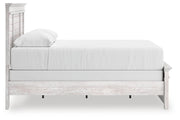 Ashley Furniture Makidern Bed showing a modern bed frame with a sleek headboard and neutral upholstery.
