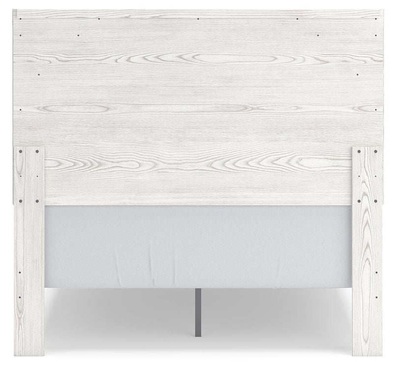 Ashley Furniture Gerridan Youth Bed with a sturdy wooden frame and classic design, shown from the back in a bedroom setting.
