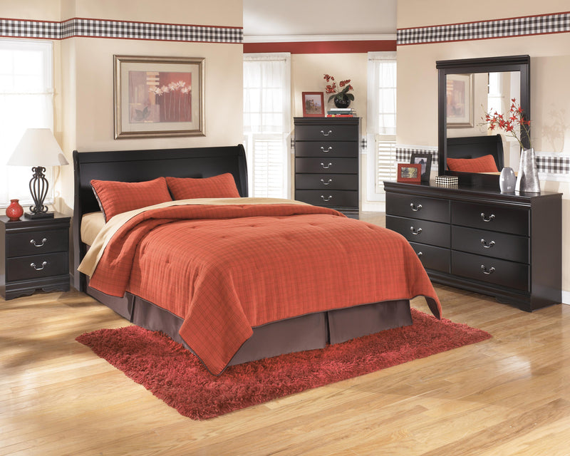 Ashley Furniture Huey Vineyard Bed with a classic wooden frame and detailed headboard, perfect for a cozy bedroom setting.