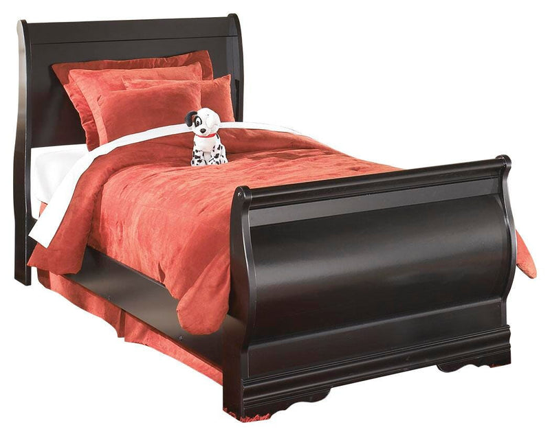 Ashley Furniture Huey Vineyard bedroom set with a bed, dresser, and nightstand in a cozy, rustic bedroom setting.