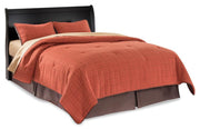 Ashley Furniture Huey Vineyard Bed in warm wood finish with slatted headboard and sturdy frame, ideal for a cozy bedroom setting.