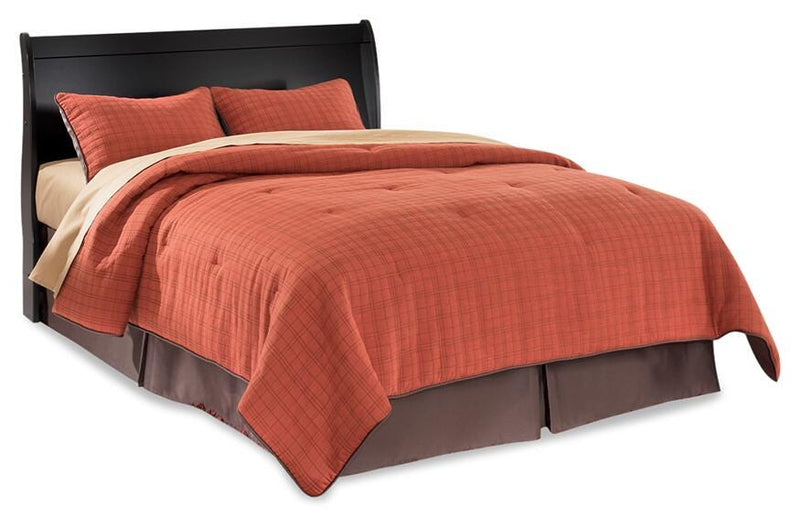 Ashley Furniture Huey Vineyard Bed in warm wood finish with slatted headboard and sturdy frame, ideal for a cozy bedroom setting.
