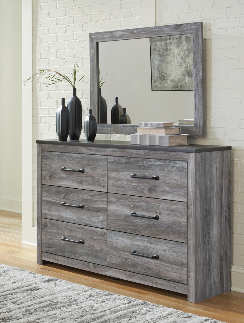 Ashley Furniture Bronyan dresser with matching mirror, featuring a modern wood finish and sleek design for bedroom storage.