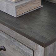 Ashley Furniture Bronyan chest of drawers with detailed wood finish and sleek top surface, showcasing its elegant storage design.