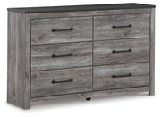 Ashley Furniture Bronyan dresser with multiple drawers, wood finish, and modern design, shown from an angled closed view.