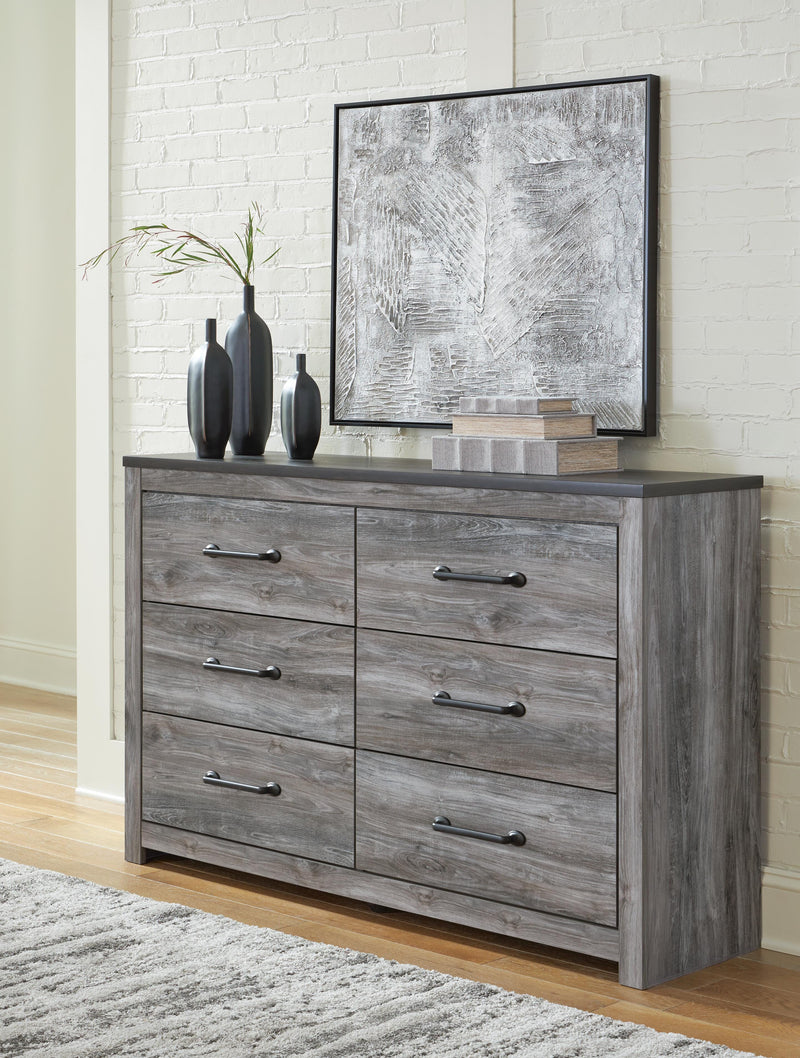 Ashley Furniture Bronyan dresser with multiple drawers and wood finish, showcasing its classic bedroom storage design.