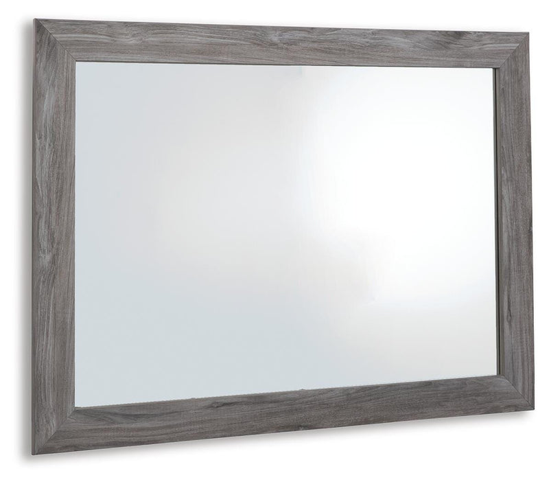 Ashley Furniture Bronyan bedroom mirror with a sleek rectangular design, shown from an angled side view.