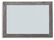 Ashley Furniture Bronyan bedroom mirror showing a sleek, rectangular design with a reflective glass surface.