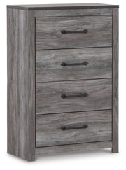 Ashley Furniture Bronyan chest of drawers, angled view showing wood finish and multiple drawer fronts in a modern bedroom setting.