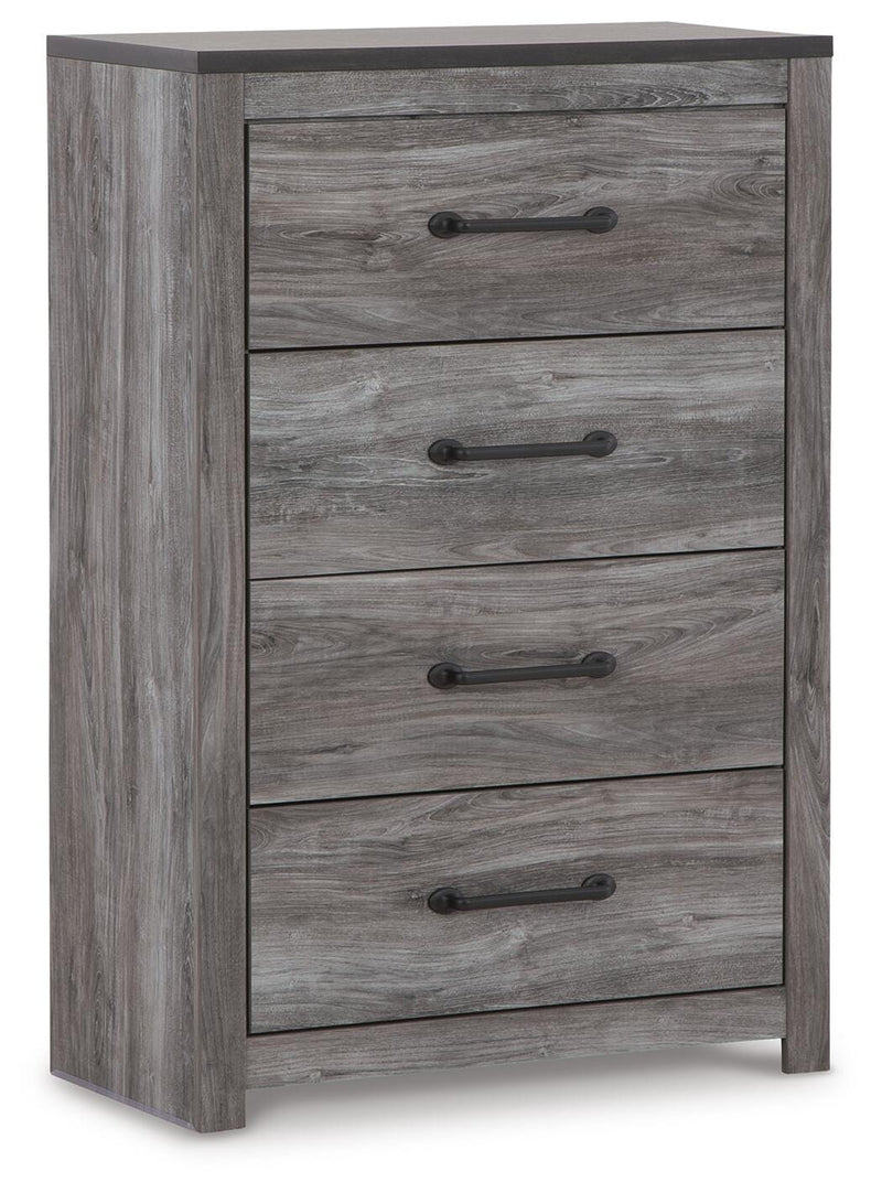 Ashley Furniture Bronyan chest of drawers, angled view showing wood finish and multiple drawer fronts in a modern bedroom setting.