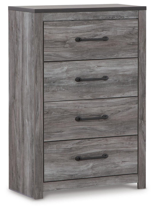 Ashley Furniture Bronyan chest of drawers, angled view showing wood finish and multiple drawer fronts in a modern bedroom setting.