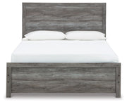 Ashley Furniture Bronyan bedroom set featuring a stylish bed frame with a headboard and matching bedroom furniture in a cozy room setting.