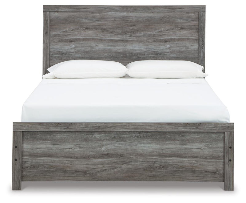 Ashley Furniture Bronyan bedroom set featuring a stylish bed frame with a headboard and matching bedroom furniture in a cozy room setting.