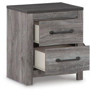 Ashley Furniture Bronyan bedroom set with a bed, nightstands, and dresser arranged in a modern bedroom scene.