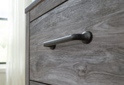 Close-up of Ashley Furniture Bronyan Dresser showing detailed wooden handles and rich brown finish.