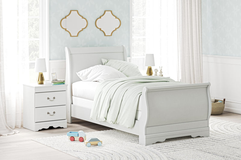 Ashley Furniture Anarasia Bed with upholstered headboard and wooden frame, shown in a stylish bedroom setting.