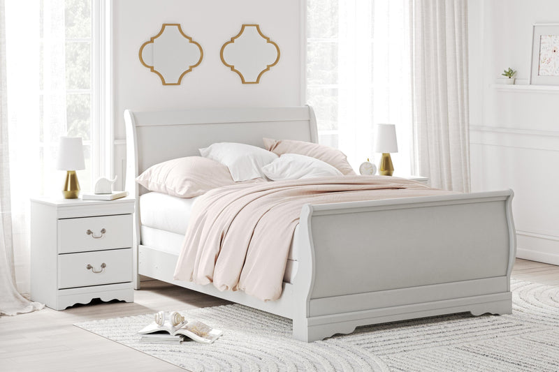 Ashley Furniture Anarasia Bed with a stylish wooden frame and upholstered headboard, shown in a cozy bedroom setting.