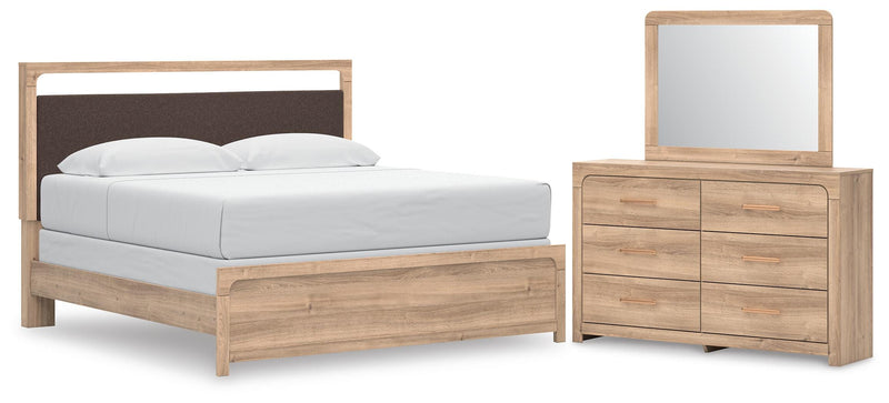 Ashley Furniture Kinlanni bedroom set with matching bed frame, nightstands, and dresser in a modern bedroom interior.