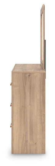 Ashley Furniture Kinlanni bedroom set with matching bed frame, nightstands, and dresser in a modern bedroom scene.